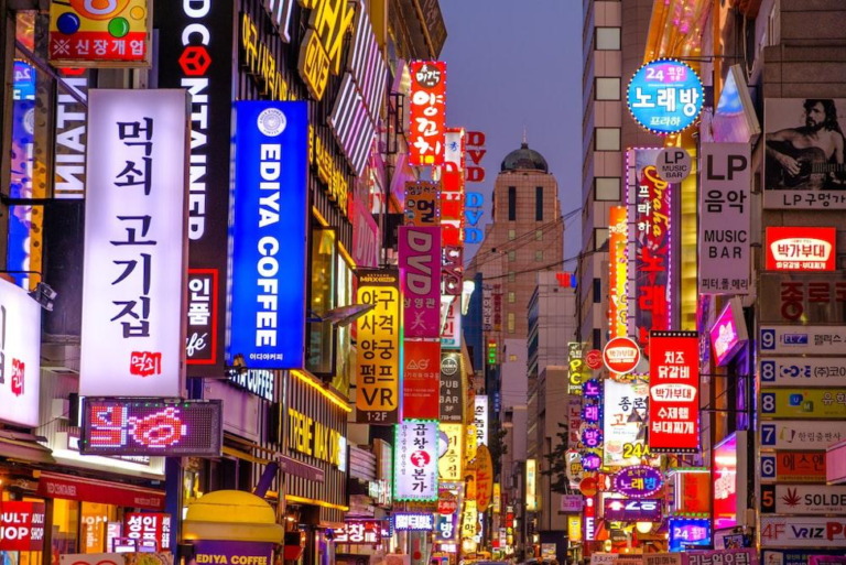 downtown seoul with neon signs above street