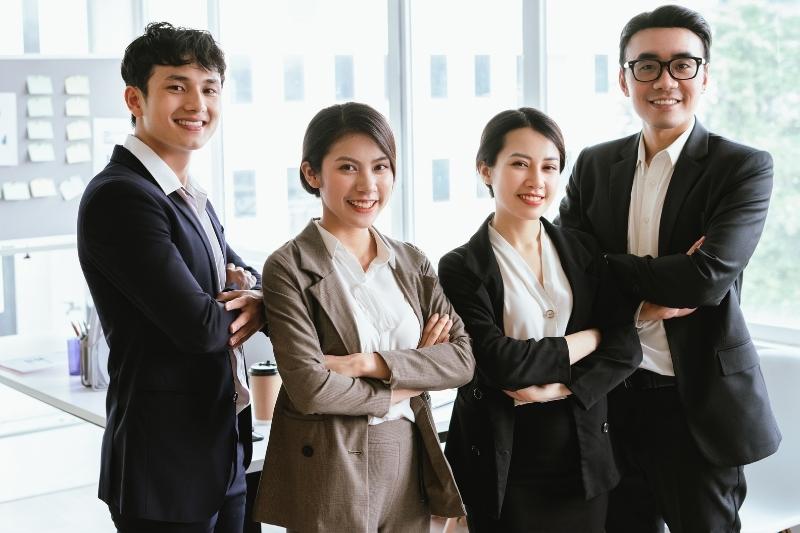 Two Korean women and two Korean men in business attire