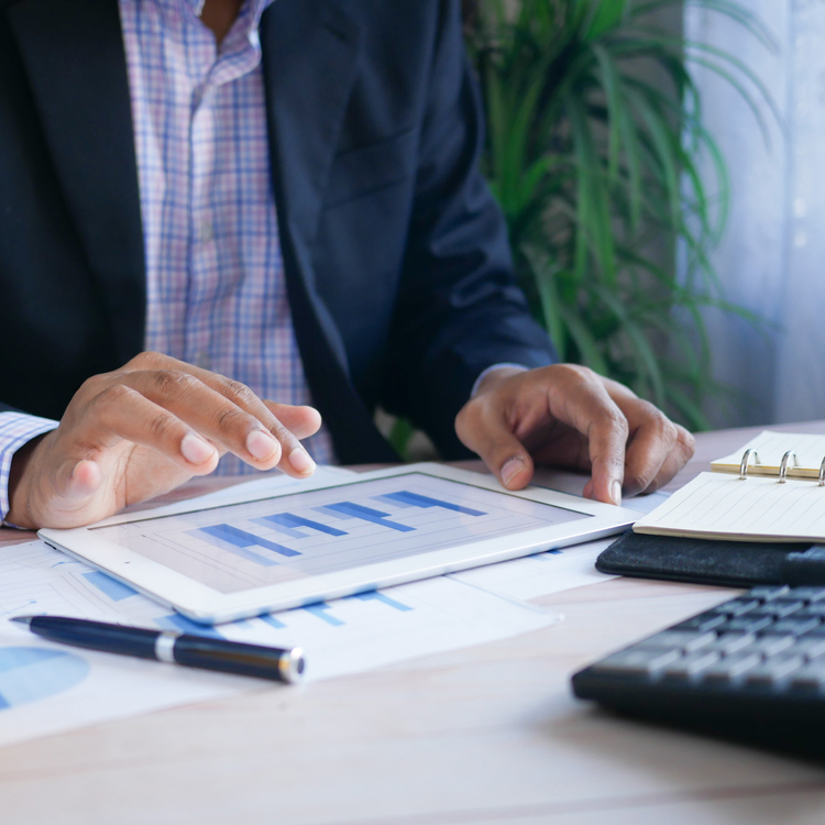 financial analyst looking at report on a tablet