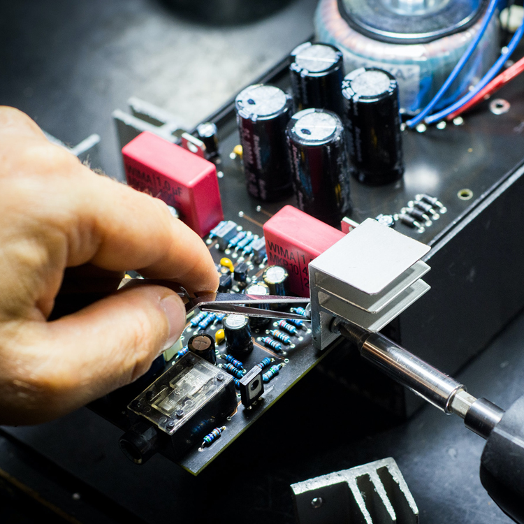 hand and screwdriver working manufacturing an electronic component