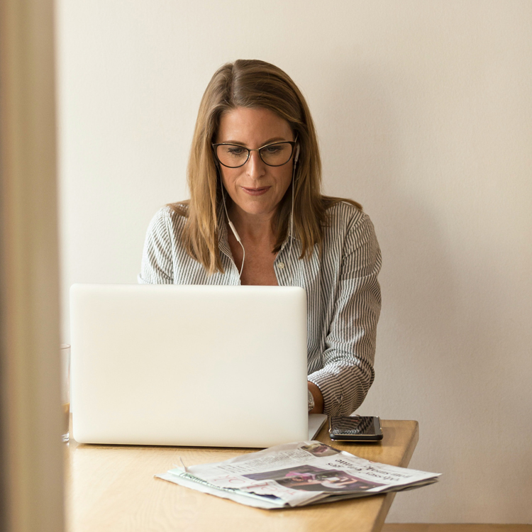 woman attending remote interpreting meeting on laptop