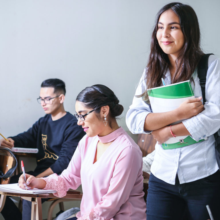 three international students in a classroom