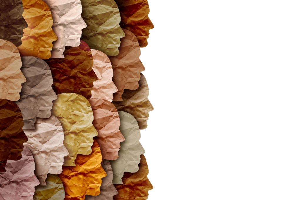 papers of different hues of brown cut into shapes of profiles of human head